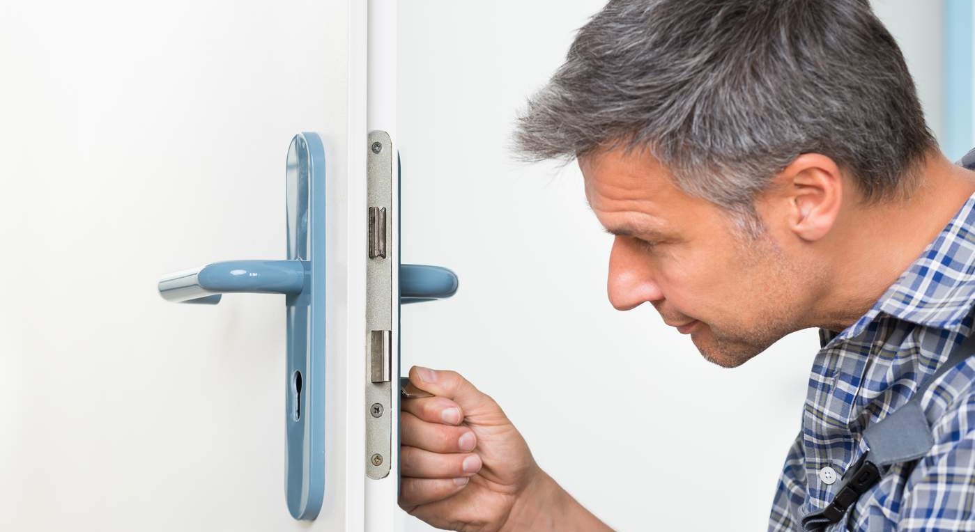 Man inspecting a door lock